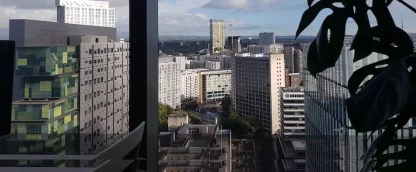 View of tall buildings from the window of the Manchester office